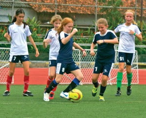 Halle Richards gains possession of the ball in a Coca-Cola League game