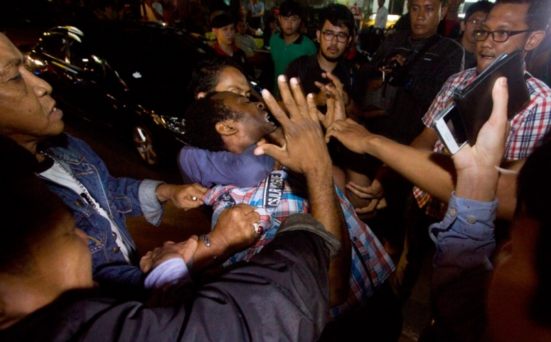 A Nigerian may is forcibly detained in an immigration raid in Jakarta. Photo courtesy of Antara