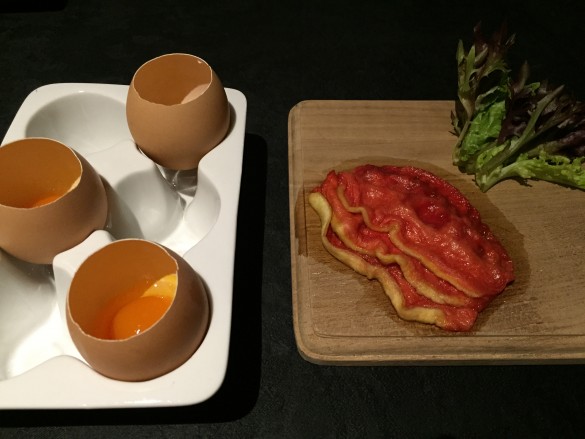 "A plate of what appeared to be a few slices of sukiyaki-style slices of raw beef paired with raw eggs served in their own shell"