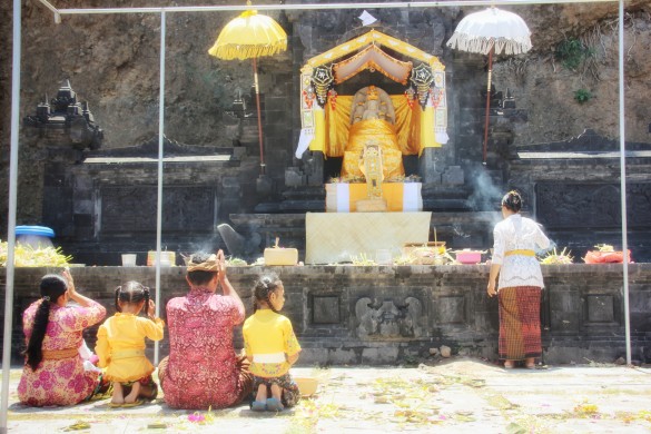 Family offering galungan prayers at hindu temple karangasem east-bali