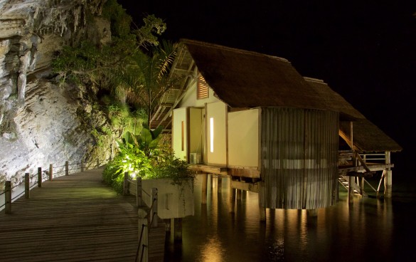 A waste water garden glows in the warm light of Misool's boardwalk and Water Cottages