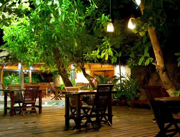 Table for two by evening light at Misool’s lagoon terrace restaurant.