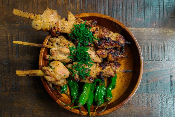  chicken skewers over shishito peppers
