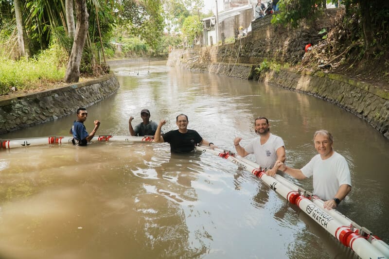 Bali Hotels Association Directors installing the river barrier at Ayung River