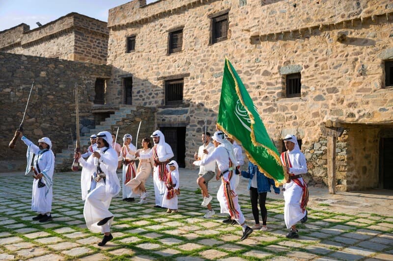 Tourists marching with guards at Bin Raqoush Palace