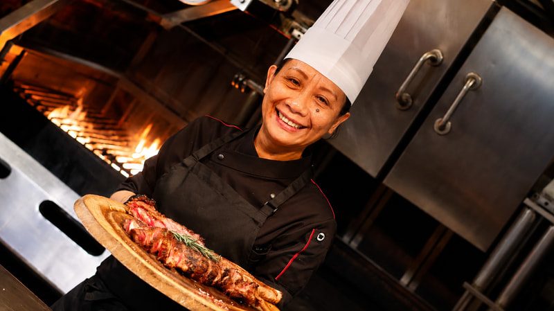 The Woman Behind the Fire: Meet Ernawati Ginting, the Culinary Force Behind HENRY’S Steakhouse