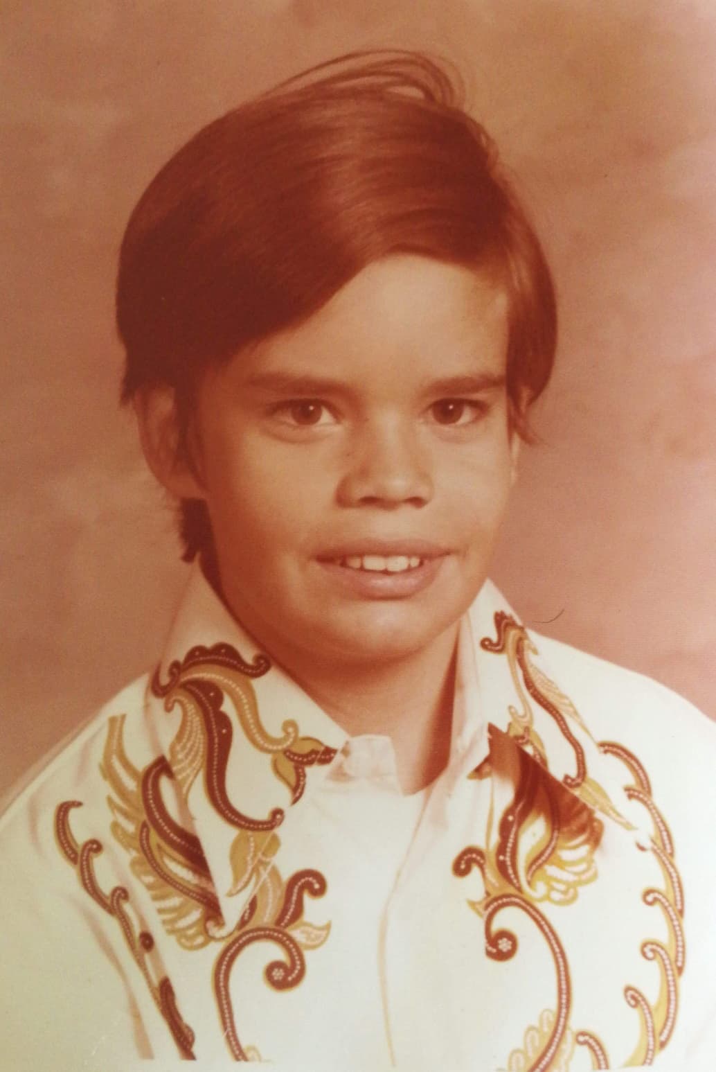 Young Mario wears a batik shirt, a gift from his father after a visit to Indonesia.